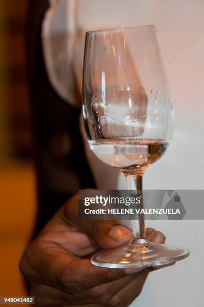 Photo taken on April 12, 2018 shows rum tasting at the Bologne Rum Distillery in Basse-Terre, in the French overseas territory of Guadeloupe. / AFP...