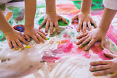 Close up colored kids hands on the table