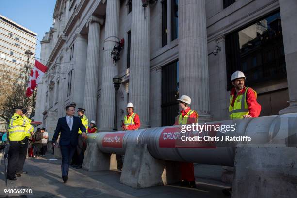 Greenpeace activists build a wood and card 'oil pipeline' outside the Canadian High Commission, Canada House, to protest against the Trudeau...