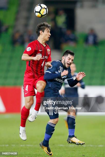 Wang Shenchao of Shanghai heads the ball over Christian Theoharous of the Victory during the AFC Champions League match between Melbourne Victory and...