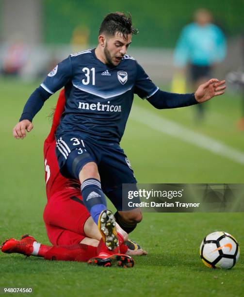 Fu Huan of Shanghai put a crude tackle on Christian Theoharous of the Victory during the AFC Champions League match between Melbourne Victory and...