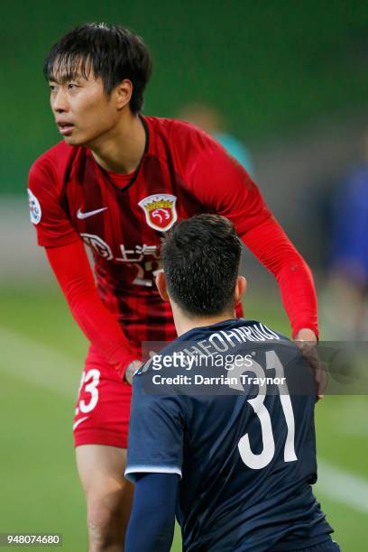 Fu Huan of Shanghai shakes the hand of Christian Theoharous of the Victory after he laid a crude tackle during the AFC Champions League match between...
