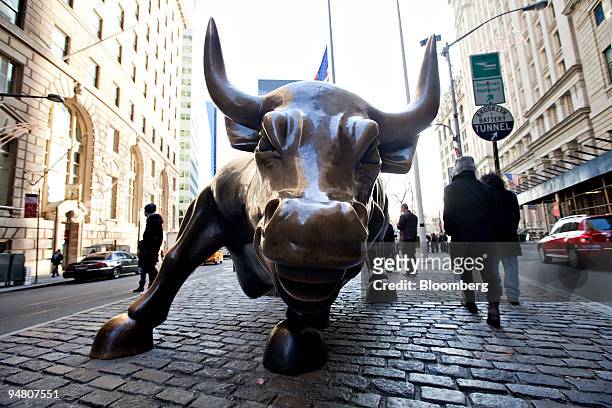 Bull statue stands in the Financial District near the New York Stock Exchange in New York, U.S., on Friday, Dec. 18, 2009. U.S. Stocks rose, trimming...