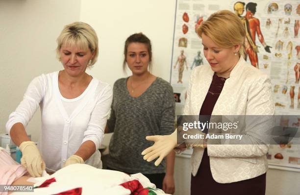 Simone Thiedecke, caregiver instructor , shows Family Minister Franziska Giffey how to replace a catheter bandage on a training dummy as Giffey...