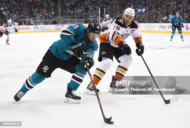 Mikkel Boedker of the San Jose Sharks skates up ice with control of the puck pursued by Ryan Getzlaf of the Anaheim Ducks during the second period in...