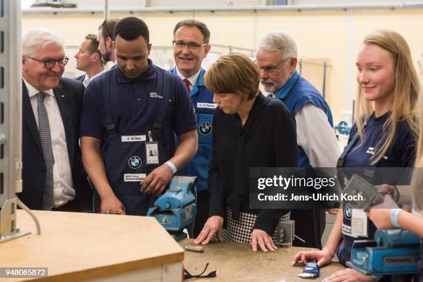 German President Frank-Walter Steinmeier and his wife Elke Buedenbender talk to trainees and training teachers at BMW Group Plant Leipzig on April...