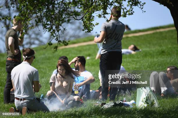 Members of the public enjoy the sunshine on Primrose Hill as spring temperatures arrive on April 18, 2018 in London, England. London is expected to...