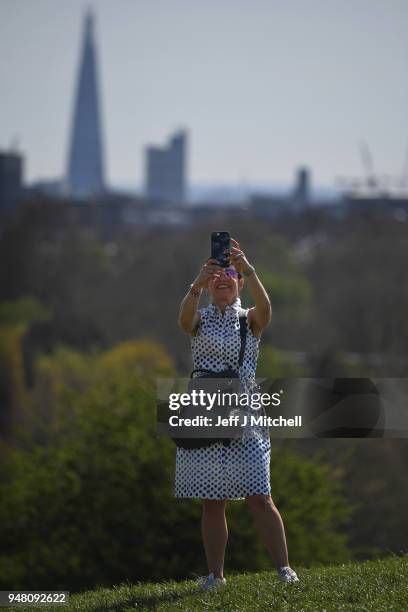 Members of the public enjoy the sunshine on Primrose Hill as spring temperatures arrive on April 18, 2018 in London,England. London is expected to be...