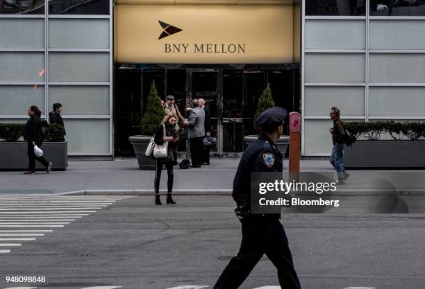 Pedestrians walk past the Bank of New York Mellon Corp. Office building in New York, U.S., on Wednesday, April 11, 2018. Bank of New York Mellon is...