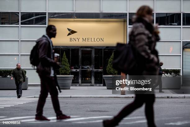 Pedestrians walk past the Bank of New York Mellon Corp. Office building in New York, U.S., on Wednesday, April 11, 2018. Bank of New York Mellon is...