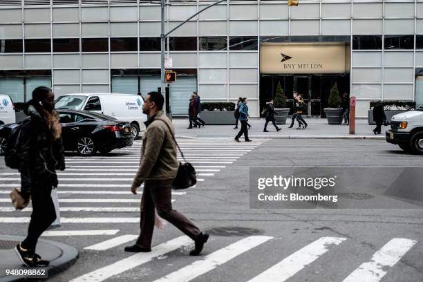Pedestrians walk past the Bank of New York Mellon Corp. Office building in New York, U.S., on Thursday, April 12, 2018. Bank of New York Mellon is...