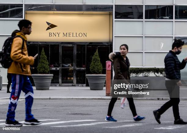 Pedestrians walk past the Bank of New York Mellon Corp. Office building in New York, U.S., on Wednesday, April 11, 2018. Bank of New York Mellon is...