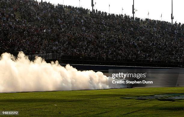 Jimmie Johnson, driver of the Lowe's Chevrolet, performs a burnout to celebrate winning the NASCAR Sprint Cup Series Pepsi 500 at Auto Club Speedway...