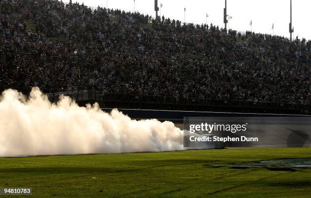 Jimmie Johnson, driver of the Lowe's Chevrolet, performs a burnout to celebrate winning the NASCAR Sprint Cup Series Pepsi 500 at Auto Club Speedway...