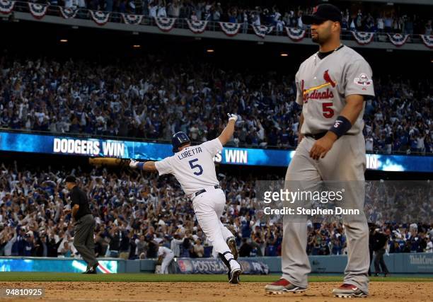 Mark Loretta of the Los Angeles Dodgers reacts as he hits a walk-off RBI single to center to score Casey Blake to defeat the St. Louis Cardinals as...