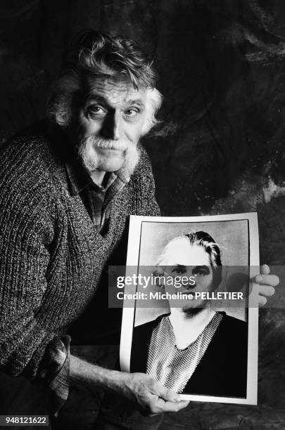 French author and satirical newspaper editor Francois Cavanna posing with his mother's portrait.