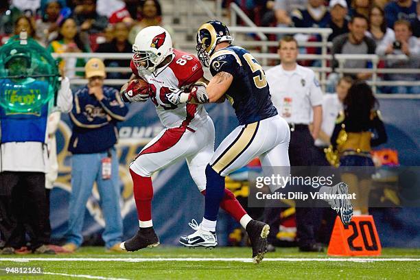 Ben Patrick of the Arizona Cardinals carries the ball against James Laurinaitis of the St. Louis Rams at the Edward Jones Dome on November 22, 2009...