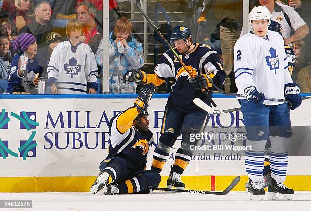 Michael Grier of the Buffalo Sabres is congratulated for his second period goal by teammate Thomas Vanek alongside Luke Schenn of the Toronto Maple...