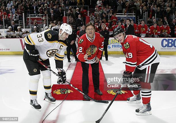 Hall of Fame catcher Carlton Fisk , formerly of the Chicago White Sox, drops the puck with Zdeno Chara of the Boston Bruins and Jonathan Toews of the...