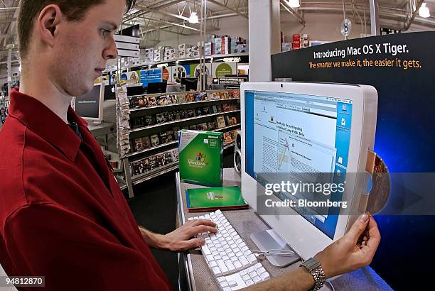 David Mason, assistant sales manager at a CompUSA store in Orem, Utah, prepares to install Windows XP on an Apple Intel iMac computer on Wednesday,...