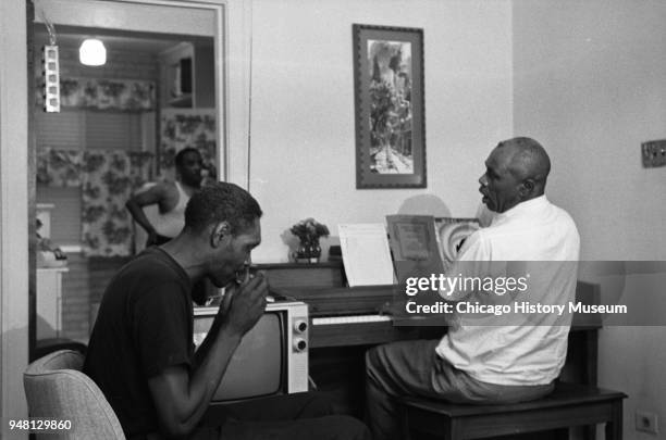 American Blues musicians Big Walter Horton , on harmonica, and Sunnyland Slim , on the piano, play together in the home of Little Brother Montgomery...