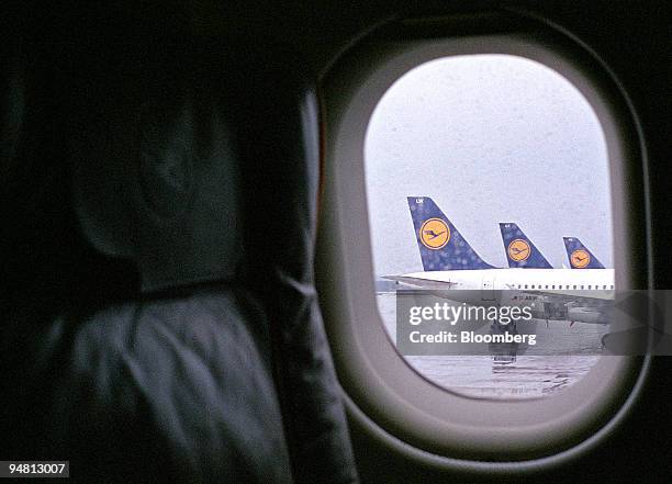 Lufthansa planes are seen on the tarmac through a plane's window at the airport in Munich, Germany, Sunday, April 9, 2006.
