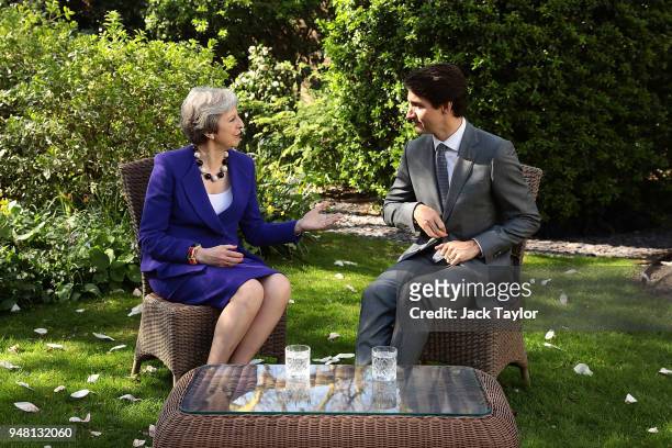 British Prime Minister Theresa May speaks with Canadian Prime Minister Justin Trudeau at Downing Street on April 18, 2018 in London, England. Mrs May...