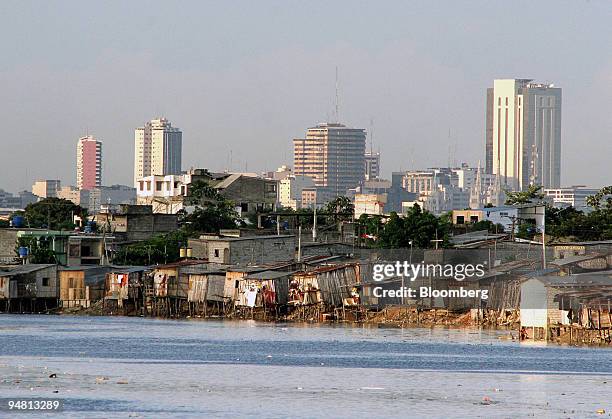 Shanty town is pictured on the shores of the Estero Salado estuary in Guayaquil, Ecuador April 26, 2005. In the background appear more modern office...