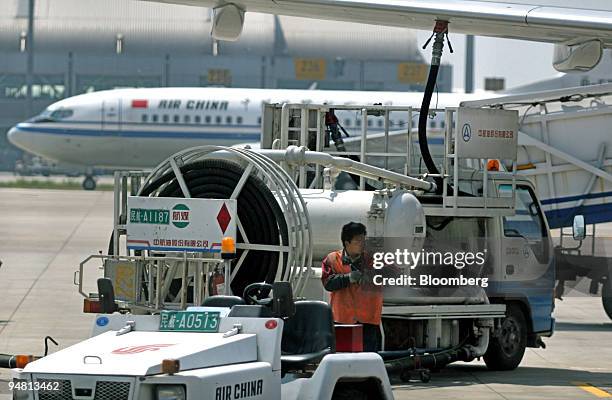 China Aviation Oil Corp. Fuel truck refuels a plane at Beijing's Shoudu Capital Airport Wednesday, May 11, 2005. CAO, forced to seek bankruptcy...