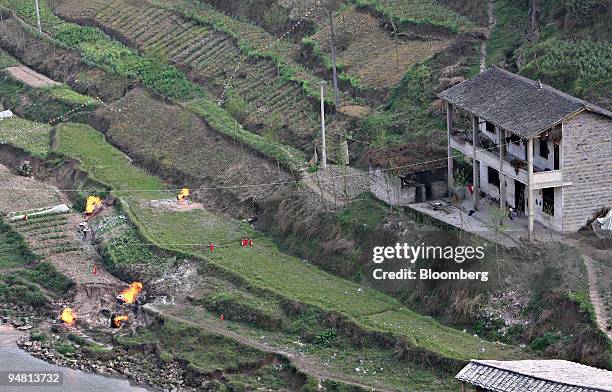 Leaking gas is burned off in Gao Qiao village, Kai Xian county, Chongqing Municipality, China, Friday, March 31, 2006. China's government said China...