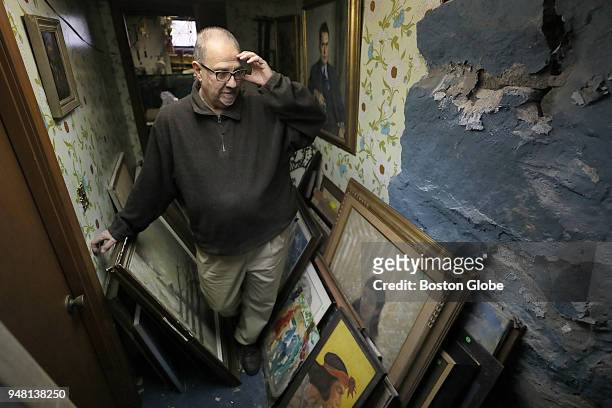 James Pantages stands among part of his collection of more than 1,100 pieces of artwork at his home in Quincy, MA on April 2, 2018. For many years,...