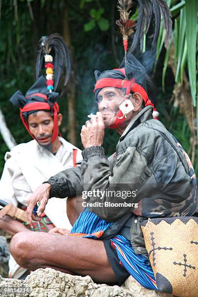 An animist priest smokes at the start of the Pasola festival in Wanokaka, Sumba Island, Indonesia, on March 21, 2006. The Pasola is the strangest...