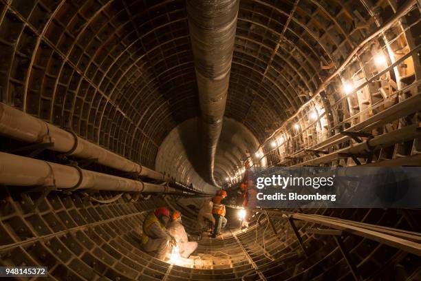 Workers for Mosmetrostroy OJSC take a break after sand blasting the cast iron seams lining the newly excavated underground rail tunnels at the...
