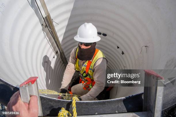 Worker prepares to check ground water levels during construction of a runway at the New International Airport of Mexico City in Texcoco, Mexico, on...