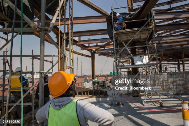 Workers build the flight control tower of the New International Airport of Mexico City during construction in Texcoco, Mexico, on Friday, April 13,...