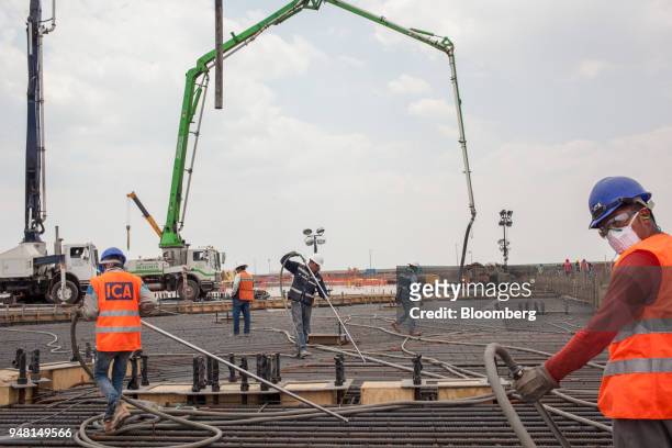 Workers build a terminal at the New International Airport of Mexico City during construction in Texcoco, Mexico, on Friday, April 13, 2018. Mexico's...