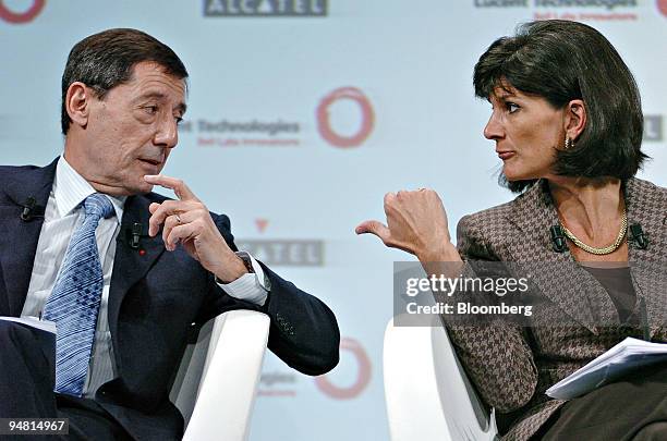 Serge Tchuruk, chairman and CEO of Alcatel SA, left, and Patricia Russo, chairman and CEO of LucentTechnologies, talk to one another at a news...
