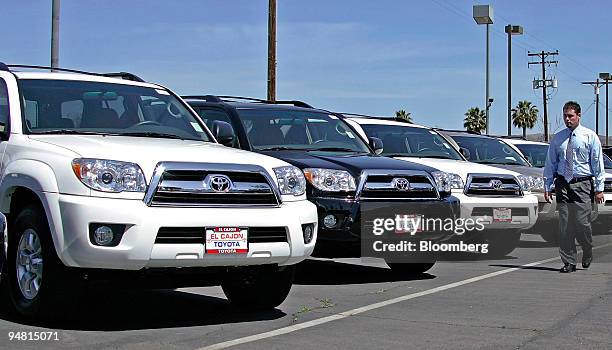 Toyota of El Cajon salesman Shawn Hayes walks past a row of Toyota 4-Runner sport utility vehicles as he checks the dealership's inventory Sunday...