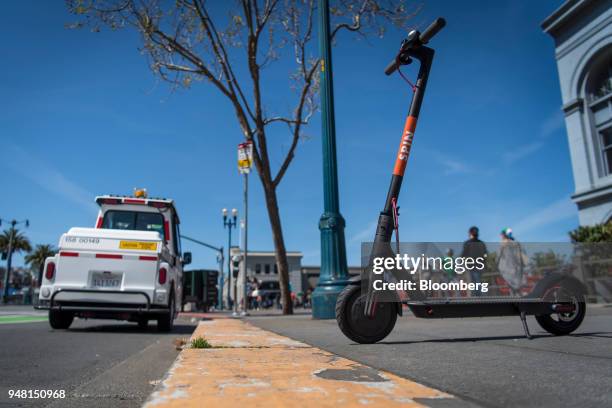 Skinny Labs Inc. SpinBikes shared electric scooter sits parked on a sidewalk next to the Embarcadero in San Francisco, California, U.S., on Friday,...