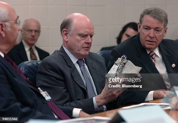 Treasury Secretary John W. Snow looks at an electronic ballist made in Western North Carolina while participating in a roundtable discussion at Blue...