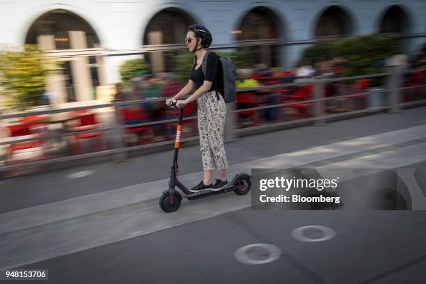 Person rides a Skinny Labs Inc. SpinBike shared electric scooter on the Embarcadero in San Francisco, California, U.S., on Friday, April 13, 2018....