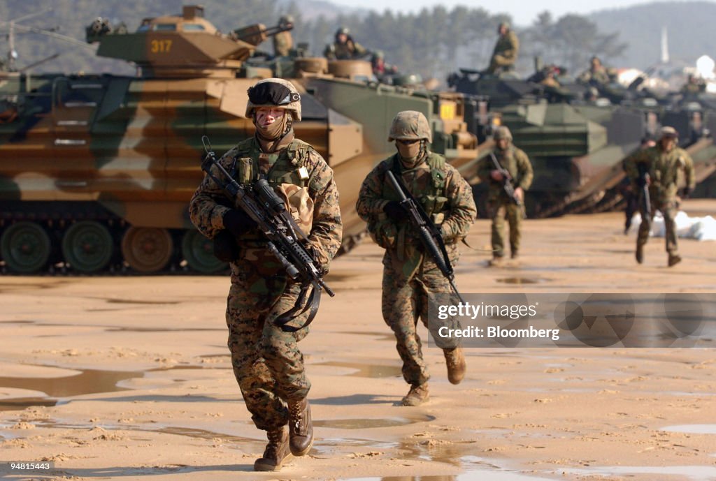 U.S. marines run from their tanks during a beach landing ope