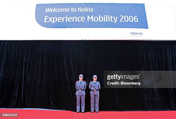 Security guards stand outside a news conference in Chongqing, China, Thursday, March 30, 2006. Nokia Oyj, the world's biggest cell-phone maker, plans...