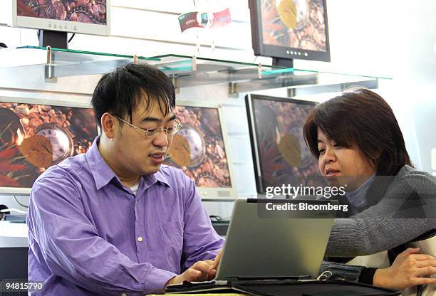 Customers browse Acer Inc. Laptop computers in an electronics store in Taipei, Taiwan, Tuesday, March 28, 2006.