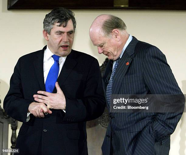 Great Britain's Finance Minister Gordon Brown, left, talks with United States Secretary of the Treasury John Snow before a group portrait during the...