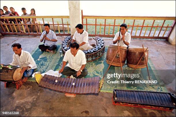 Champassak's traditional orchestra plays as the caravan takes leave.