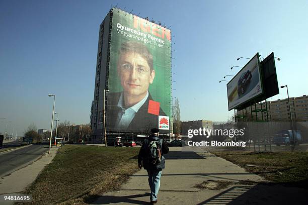 An 18 story tall campaign poster for the Hungarian socialist party featuring Hungarian prime minister Ferenc Gyurcsany covers the face of an...