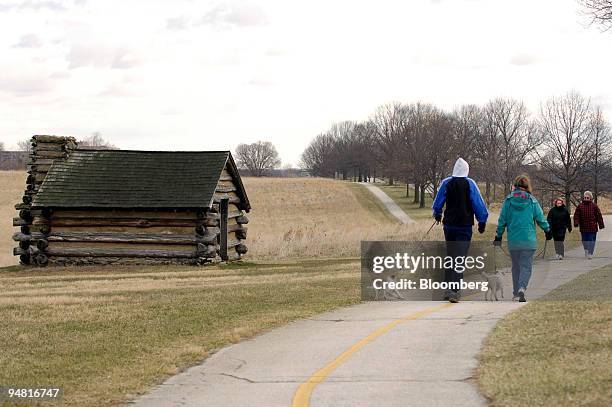 Visitors walk past one of the historic cabins at Valley Forge National Historic Park in Valley Forge, Pennsylvania on January 25, 2006. Plans to...