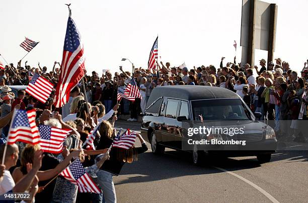 The hearse carrying former U.S. President Ronald Reagan makes it way through a throng of people en route to the Ronald Reagan Presidential Library...