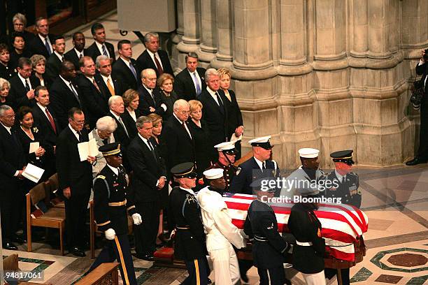 The coffin of Former President Ronald Reagan is carried into National Cathedral for the funeral service in Washington, DC June 11, 2004. Seen...